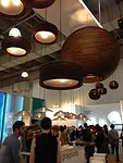 <strong>At ICFF</strong><br /> Cardboard light fixtures at the Graypants Studio booth.
