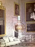 <strong>At ICFF</strong><br /> A dollhouse-size chandelier embedded in a lightbulb-shaped hanging lamp by Mineheart, based in England. The company also designs wallpaper, as seen in the background of 
