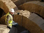 Artist Andy Goldsworthy working on Stone Sea, a permanent installation of 25 limestone arches in a space between the museum’s Main and East Buildings.