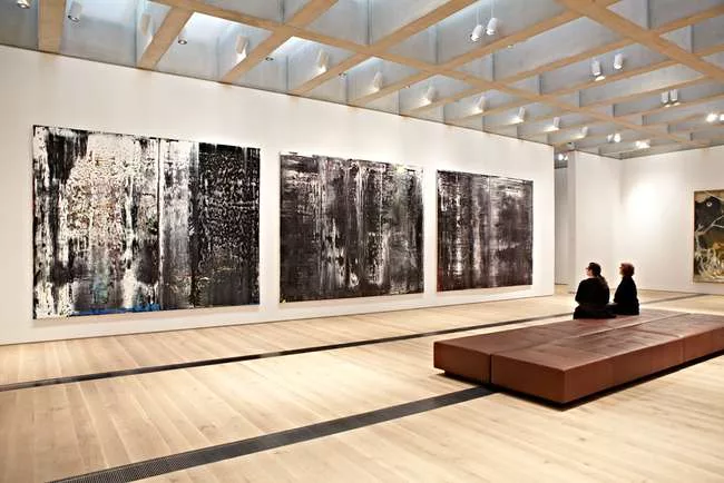 A gallery of the new East Building featuring paintings by Gerhard Richter.