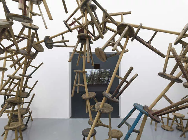 The German Pavilion includes work by artists Romuald Karmakar, Santu Mofokeng, Dayanita Singh, and Ai Weiwei. Above, Ai's <em>Bang</em>, 2010-2013, which comprises 886 antique stools.