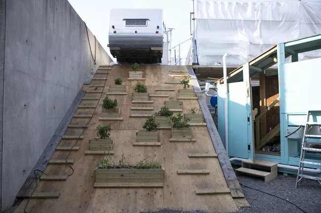A trailer perched on the second floor of the the Colony's scaffolding structure.
