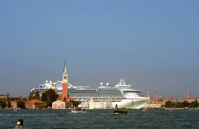 A large cruise ship emerges out of the Giudecca Canal in Venice, behind the island of San Giorgio Maggiore, 2009. <br />