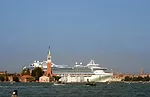 A large cruise ship emerges out of the Giudecca Canal in Venice, behind the island of San Giorgio Maggiore, 2009. <br />