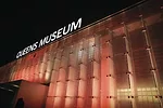 The west facade of the renovated Queens Museum features glass panels illuminated with programmable LED lighting.