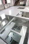 Inside the Silo Building, O-office Architects cut out rectangles in the  floors and covered them with glass, creating remarkable views through  the structure.