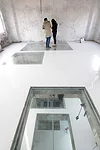 Inside the Silo Building, O-office Architects cut out rectangles in the floors and covered them with glass, creating remarkable views through the structure.