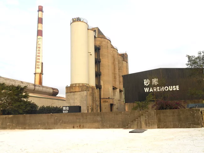 The Value Factory complex includes (from left to right): the Machine Hall and chimney, a silo building, and a warehouse.