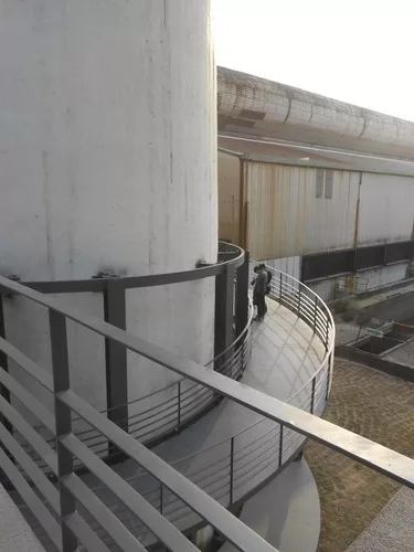 A ramp takes visitors from the restaurant building, around the base of the chimney, and to the Machine Hall.