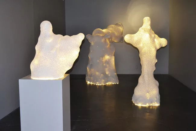 In protest of mass production, Benjamin Ball and Gaston Nogues have filled a gallery with the ambient glow of paper-mached toilet paper lamps in abstract shapes, some more than six feet tall. Due to t