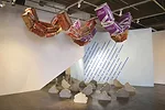 Playing with the conventions of what goes up and what comes down, Design, Bitches created an environment where concrete sacks float, blue painter’s tape showers the ground, and clouds fall like 