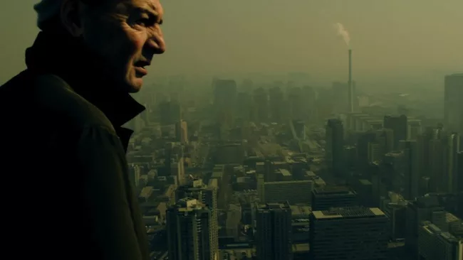 <p>Film Still from <em>REM</em>:</p><p>The architect surveys views from the top of the CCTV Headquarters in Beijing</p>