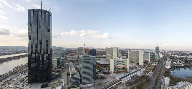 The tower, overlooking Vienna, has a facade of folded glass planes that appear to weave in and out.