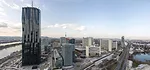 The tower, overlooking Vienna, has a facade of folded glass planes that appear to weave in and out.