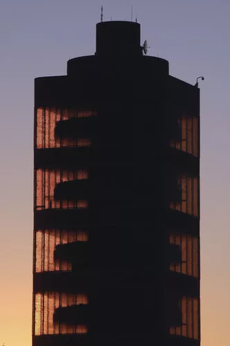 <p class='MsoNormal'>The tower's unique taproot core design is illuminated by a sunset.</p>