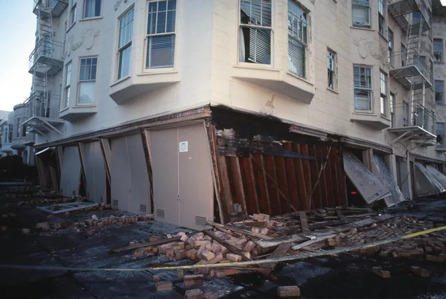 <p class='Standard'>San Francisco, California, October 17, 1989. The damage to the weak, unreinforced garage level of this building at the corner of Beach and Divisadero was typical of the failures se