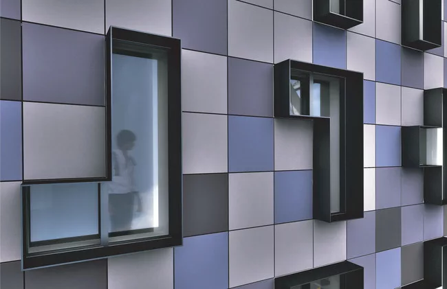 HAP 4, on West 187th Street, has a front façade consisting of Tetris-like panels in shades of blue and grey.