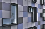 HAP 4, on West 187th Street, has a front façade consisting of Tetris-like panels in shades of blue and grey.