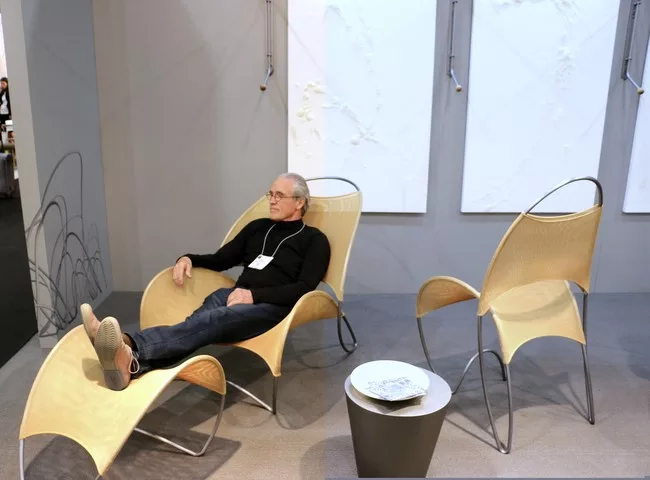 William Pedersen of Kohn Pederson Fox reclines in one of his Loop de Loop chairs at ICFF.