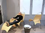 William Pedersen of Kohn Pederson Fox reclines in one of his Loop de Loop chairs at ICFF.