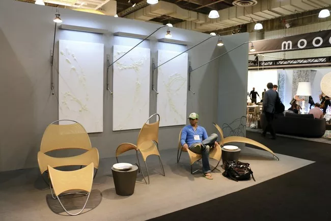 An ICFF visitor sits in on of William Pedersen’s Loop de Loop chairs.