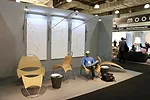 An ICFF visitor sits in on of William Pedersen’s Loop de Loop chairs.