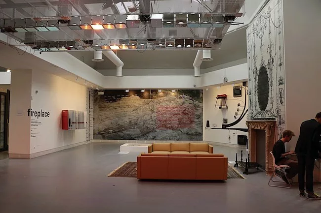 In the Fireplace gallery, a 3d print of a Piranesi fireplace and an overhead heating device developed by a team at MIT that tracks users through their mobile phone signals.