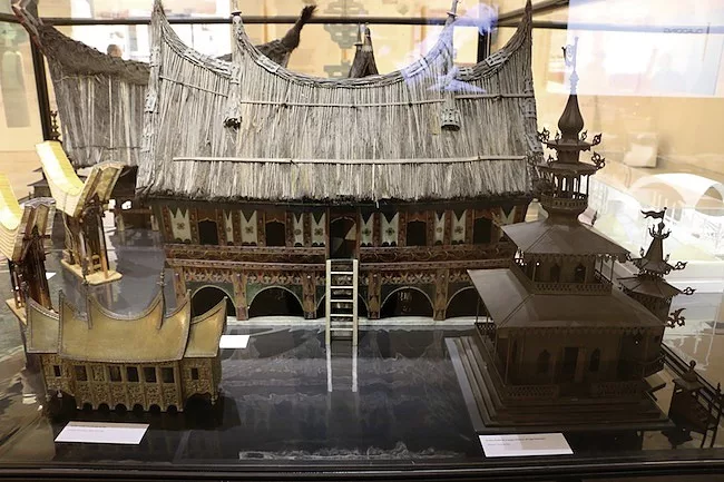 A 19th century model of an Indonesian hut stands next to a group of contemporary designs in the Roof gallery.