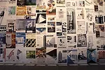 Advertisements for architectural materials line the walls in the introductory space.