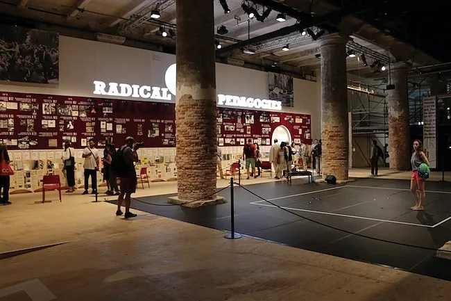 A dancer performs in front of the <em>Radical Pedagogies</em> wall. The installation by Beatriz Colomina with a group of students from the Princeton University’s School of Architecture surveys t
