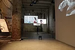 Screens hung throughout the space show important works of Italian cinema.