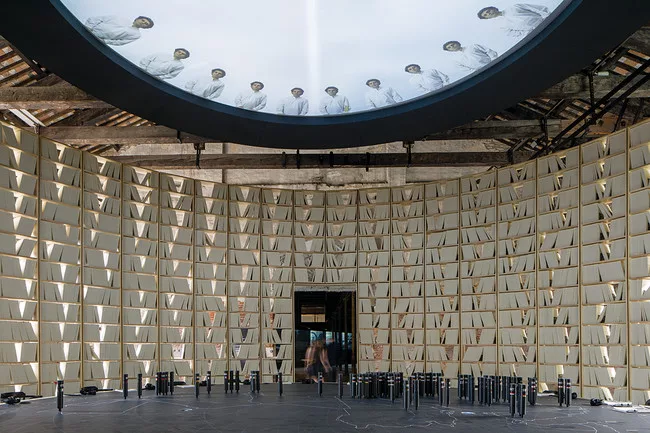 In the Bahrain pavilion a circle of bookshelves surrounds a round table showing a map of the Arab world as it was shaped over 100 years.