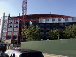 Modular housing has already obscured most of the east facade of Barclays Center, long before the building has reached its full height.