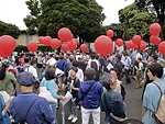 Protestors gather around the National Stadium on Saturday, hoping to save it from demolition.