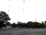 Protestors, including architect-activist Edward Suzuki (center), encircled the stadium carrying red balloons.<br /><div id='_mcePaste'>﻿﻿