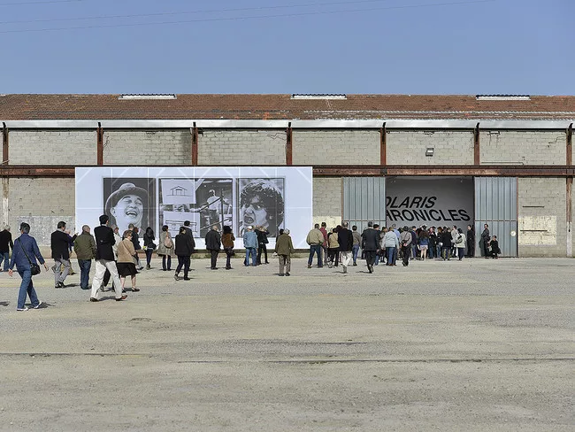 A work by John Baldessari installed on the facade of a former train repair facility. The building will be joined by a Frank Gehry-designed tower as the complex is transformed into LUMA Arles, and art
