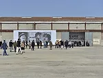 A work by John Baldessari installed on the facade of a former train repair facility. The building will be joined by a Frank Gehry-designed tower as the complex is transformed into LUMA Arles, and art 