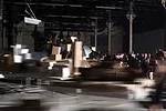 Perfromers push models of Frank Gehry's work around the exhibition according to a set of motions choreographed by artist Tino Sehgal.