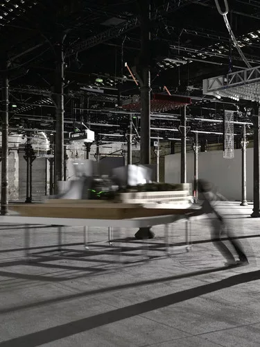 Perfromers push models of Frank Gehry's work around the exhibition according to a set of motions choreographed by artist Tino Sehgal.