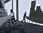 Perfromers push models of Frank Gehry's work around the exhibition according to a set of motions choreographed by artist Tino Sehgal.