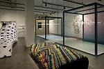 <em>Bench Press</em> by Leah Rosenberg and Matthew Rosenberg is made of multi-colored, striated rubber tubing.
