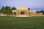 A stylized version of the hollyhock adorns the roofline.