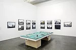 Rana Hamadeh's <em>The Big Board or ‘And Before It Falls It Is Only Reasonable To Enjoy Life A Little’</em> (2013) is surrounded by Hrair Sarkissian's photographs <em>Execution Squares</em