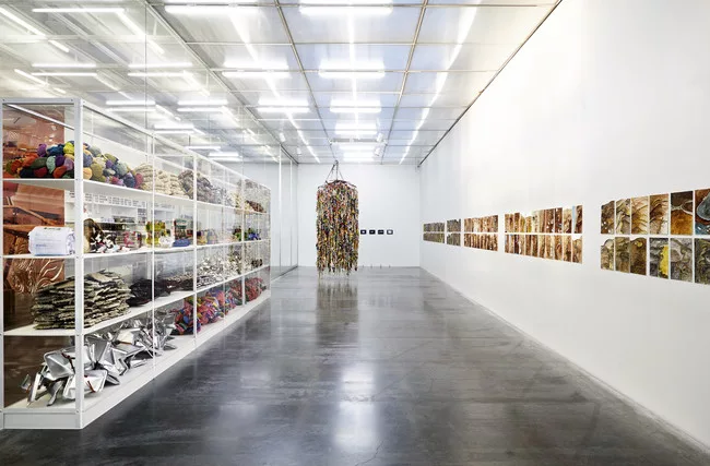 Hassan Sharif's <em>Suspended Objects</em> (2011), center, with Hassan Sharif's  surplus materials and found objects, shown at left, and Abdullah Al Saadi's <em>Camar Cande’s Journey</em> (