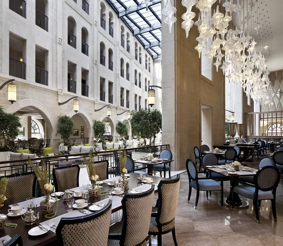 The atrium promenade features a retractable glass ceiling that floods the hotel with natural light.