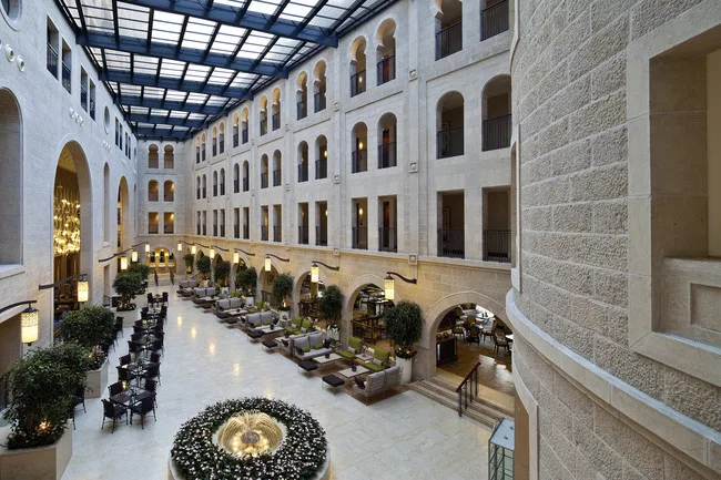 The atrium promenade features a retractable glass ceiling that floods the hotel with natural light.