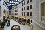 The atrium promenade features a retractable glass ceiling that floods the hotel with natural light.
