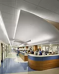 Walls in the hub of the emergency department (left) don’t exceed 5 feet in height, allowing staff to see through the nearly block-long room