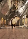 In the V&A’s Raphael Gallery, a pair of aluminum-clad blades, measuring 100 by 30 feet, rotated slowly overhead, their mirrored surfaces reflecting the wall-hung, 16th-century 'cartoons' origina
