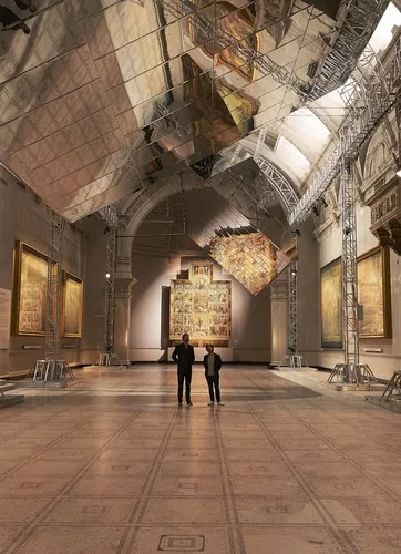In the V&A’s Raphael Gallery, a pair of aluminum-clad blades, measuring 100 by 30 feet, rotated slowly overhead, their mirrored surfaces reflecting the wall-hung, 16th-century 'cartoons' origina